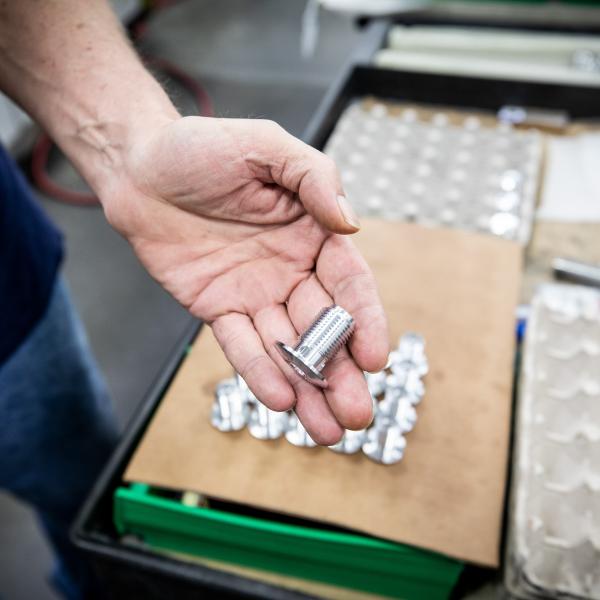 Worker holding bolt